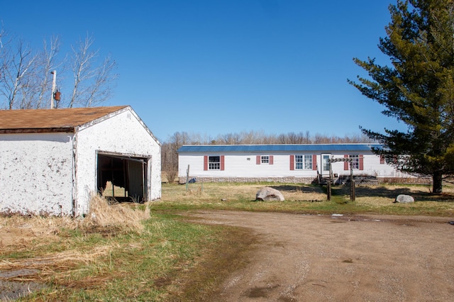 4906 32nd St SW, Pine River, MN 56474 - view of front of house featuring an outbuilding and a garage
