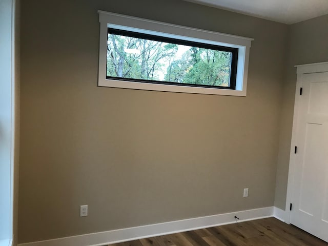 spare room with dark wood-type flooring