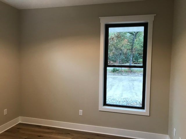 empty room featuring dark wood-type flooring