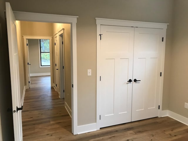 corridor with dark hardwood / wood-style floors