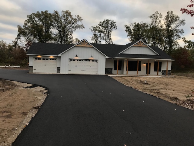 view of front of property featuring a garage and a porch