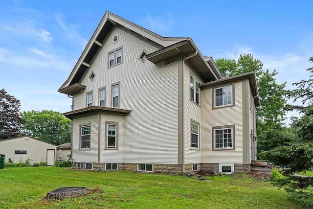 view of side of home with a lawn