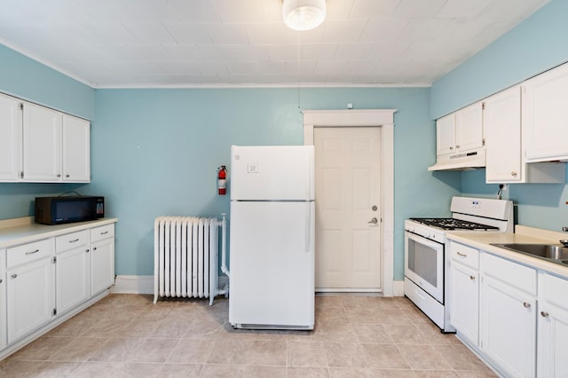 kitchen featuring radiator, light countertops, white cabinets, white appliances, and under cabinet range hood