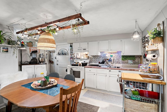 kitchen with white range with electric cooktop, white cabinets, backsplash, under cabinet range hood, and a sink