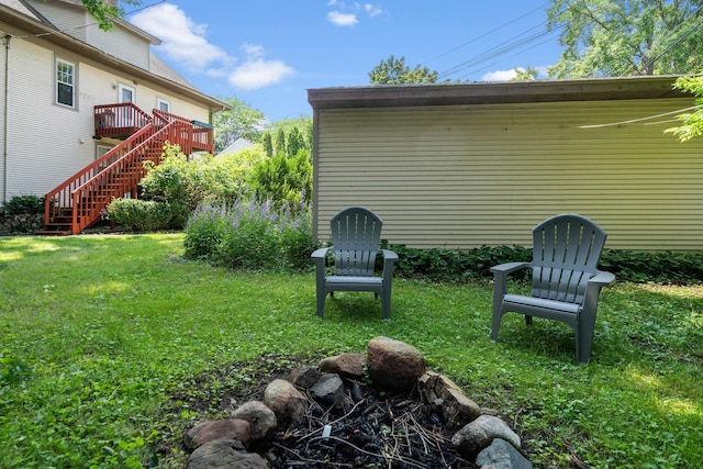 view of yard with stairway and a deck