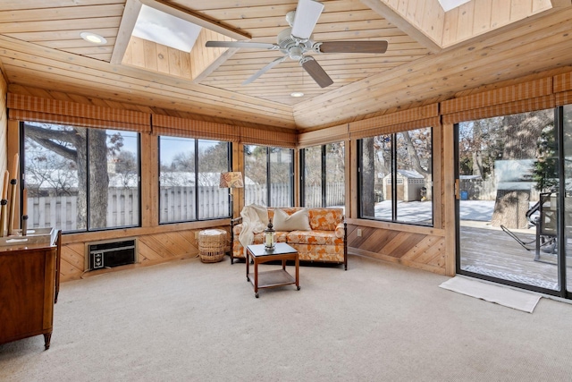 sunroom featuring wood ceiling, ceiling fan, and lofted ceiling with skylight