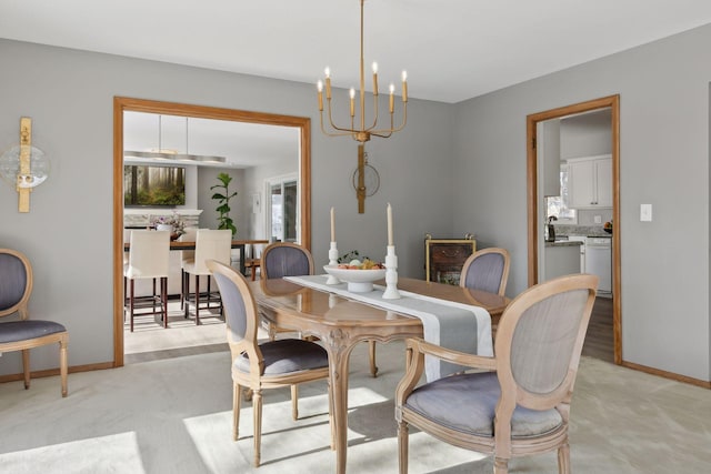 carpeted dining area with an inviting chandelier