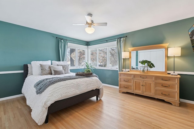 bedroom with ceiling fan and light wood-type flooring