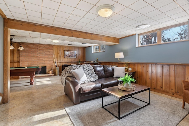 living room featuring plenty of natural light, billiards, and wood walls