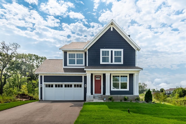 view of front facade with a garage and a front lawn