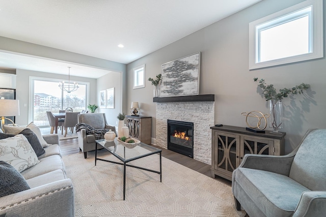 living room featuring a fireplace, light hardwood / wood-style flooring, and plenty of natural light