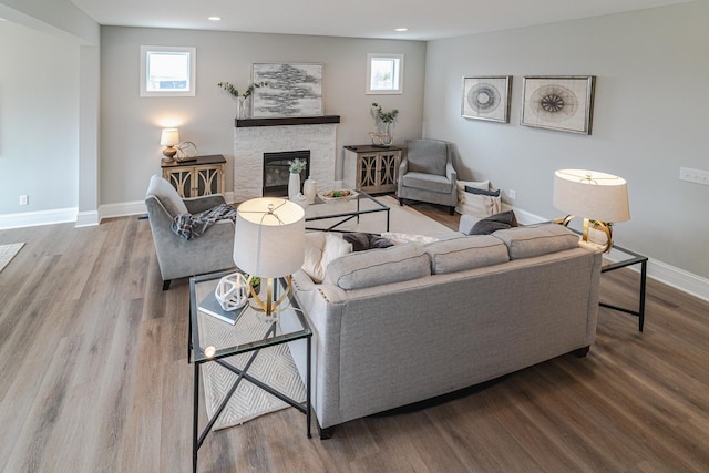 living room with hardwood / wood-style flooring and a fireplace