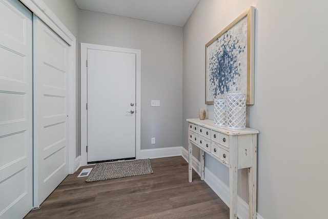 foyer entrance with dark hardwood / wood-style floors