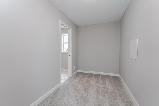 unfurnished room featuring light colored carpet