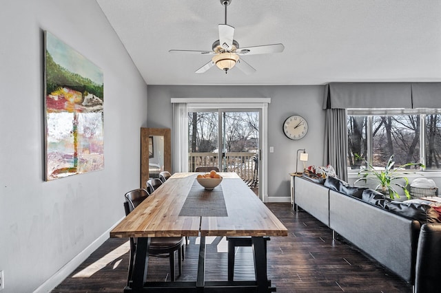 dining room featuring ceiling fan, baseboards, and dark wood finished floors