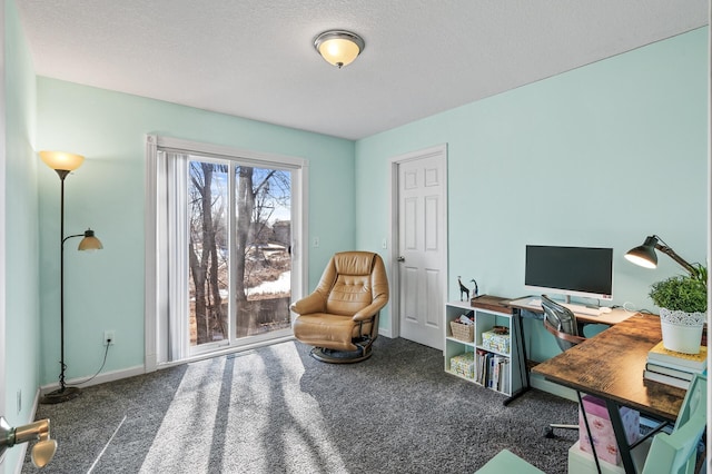 carpeted office space featuring a textured ceiling and baseboards