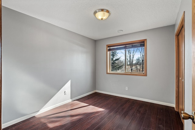 unfurnished bedroom featuring a closet, baseboards, a textured ceiling, and hardwood / wood-style floors