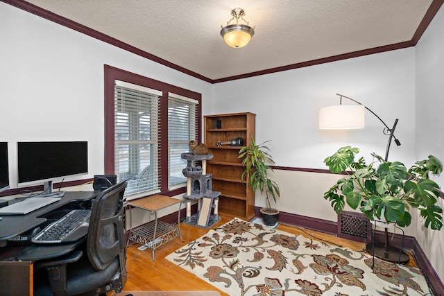 office with ornamental molding, a textured ceiling, baseboards, and wood finished floors