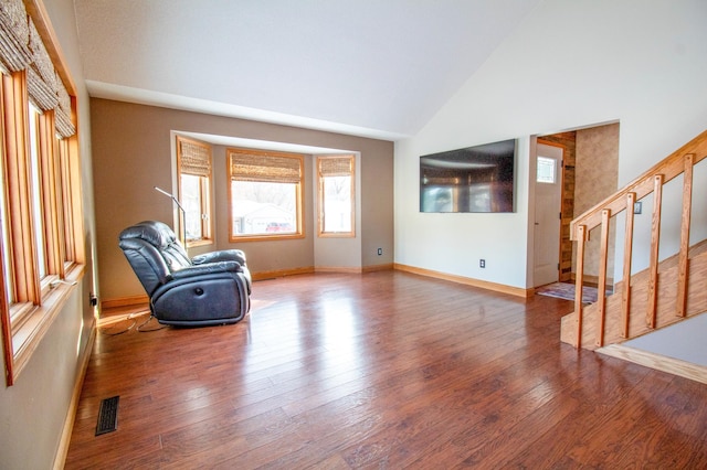 sitting room featuring hardwood / wood-style flooring and high vaulted ceiling