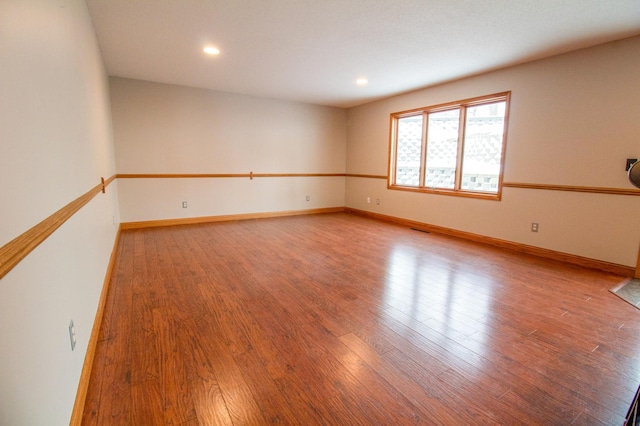 unfurnished room with light hardwood / wood-style floors