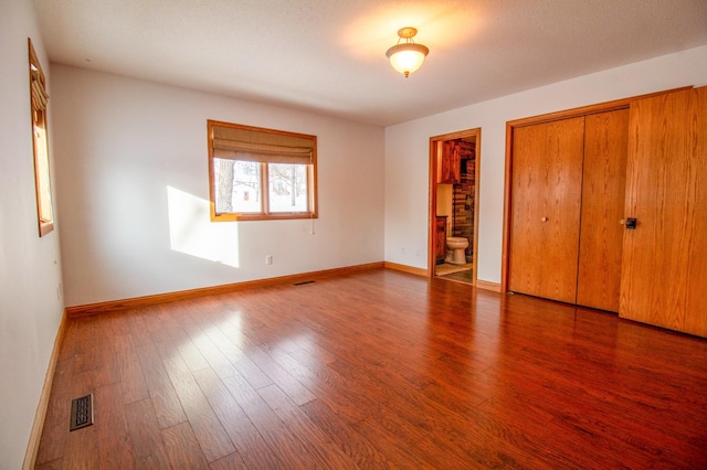 unfurnished bedroom featuring hardwood / wood-style floors and a closet