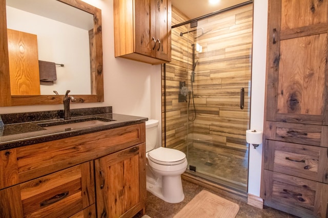 bathroom with walk in shower, vanity, and toilet