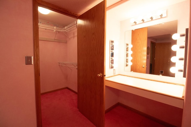 walk in closet with carpet floors