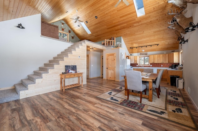 dining area with hardwood / wood-style flooring, wooden ceiling, high vaulted ceiling, and a skylight