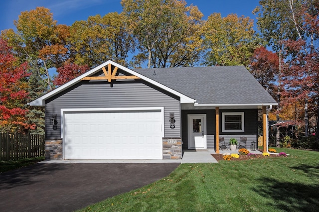 view of front of property featuring a porch, a garage, and a front lawn