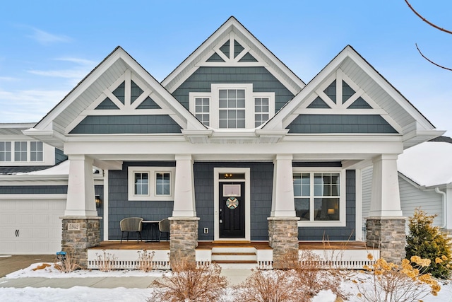 craftsman inspired home with a porch and a garage