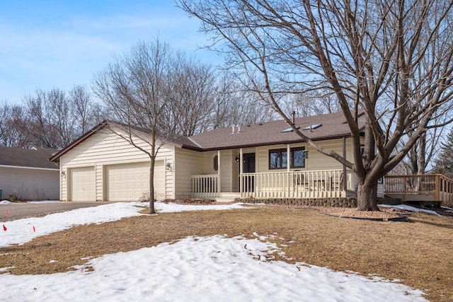 ranch-style house with a porch, an attached garage, and driveway