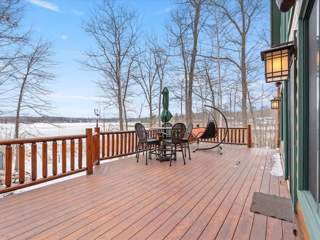snow covered deck featuring outdoor dining space