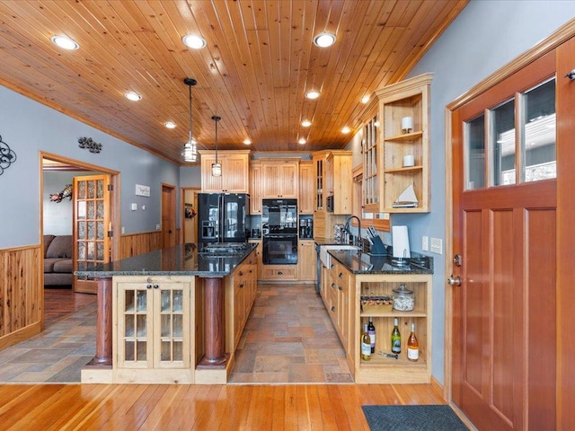 kitchen with open shelves, black appliances, a wainscoted wall, recessed lighting, and a kitchen island