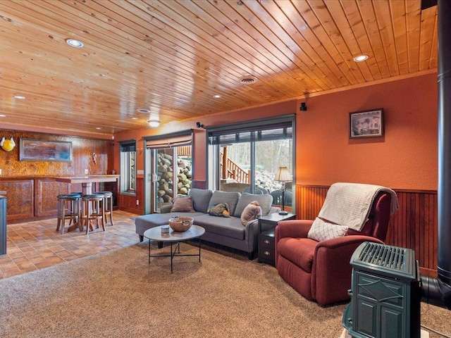 living room with wooden ceiling, wooden walls, a wainscoted wall, and recessed lighting
