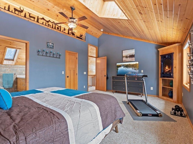 bedroom with a skylight, wood ceiling, carpet floors, vaulted ceiling, and baseboards