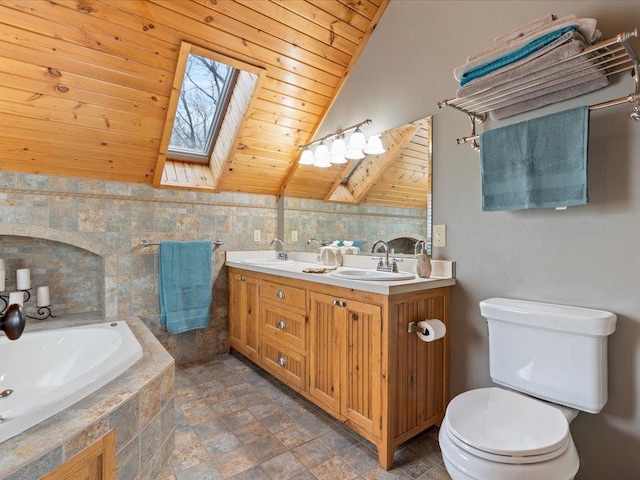 bathroom featuring a skylight, toilet, wooden ceiling, stone finish floors, and a bath