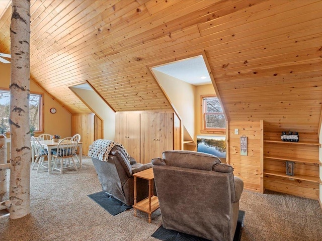 carpeted living area with vaulted ceiling, wooden walls, and wooden ceiling