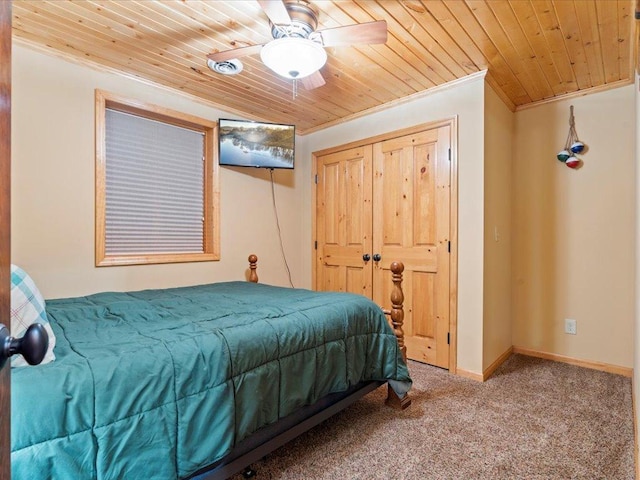 carpeted bedroom with wood ceiling, crown molding, a ceiling fan, and baseboards
