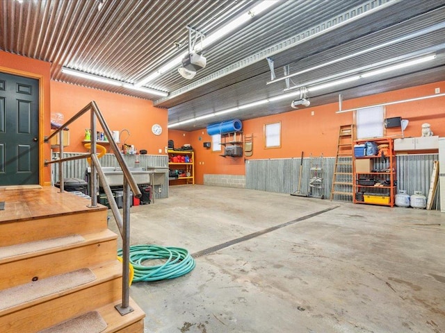garage with a workshop area and a garage door opener