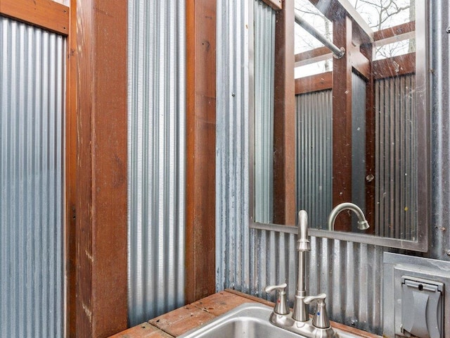 bathroom with a sink and wallpapered walls