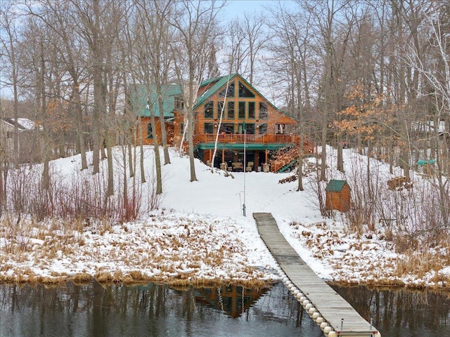 rear view of house featuring a water view