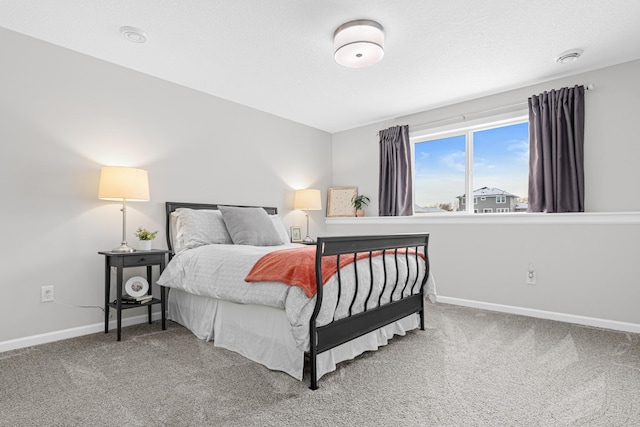 bedroom with carpet floors and a textured ceiling
