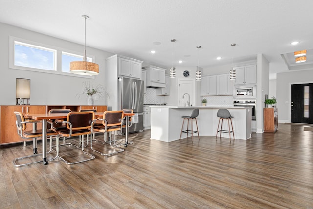 dining room featuring dark wood finished floors and recessed lighting