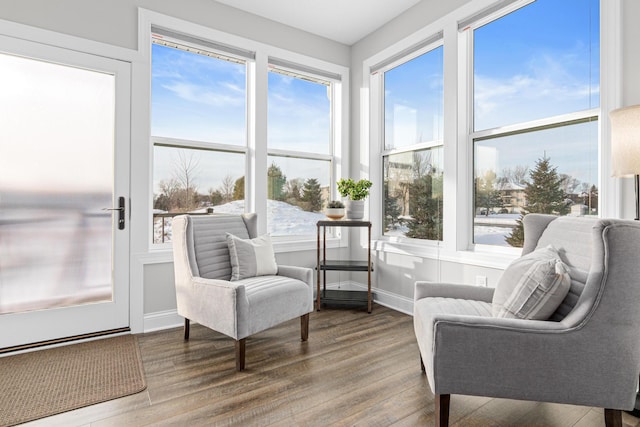sunroom / solarium featuring wood finished floors and baseboards