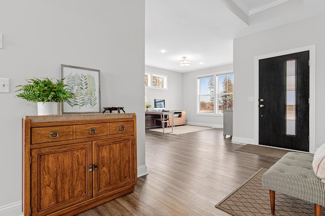 entryway featuring wood finished floors, baseboards, recessed lighting, and crown molding