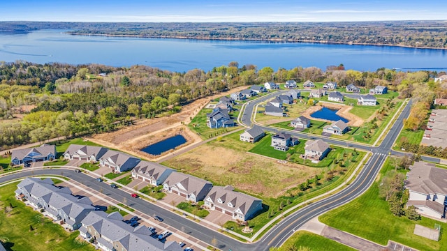 view of property location featuring a nearby body of water and nearby suburban area