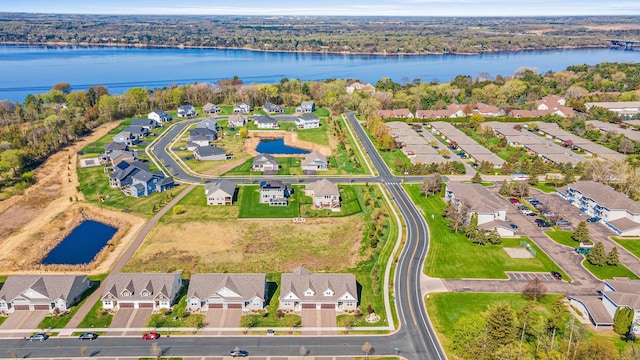 view of property location with a nearby body of water and nearby suburban area
