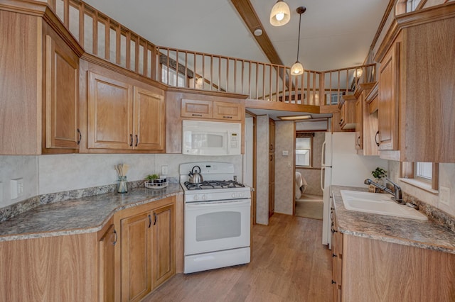 kitchen featuring sink, decorative backsplash, hanging light fixtures, white appliances, and light wood-type flooring