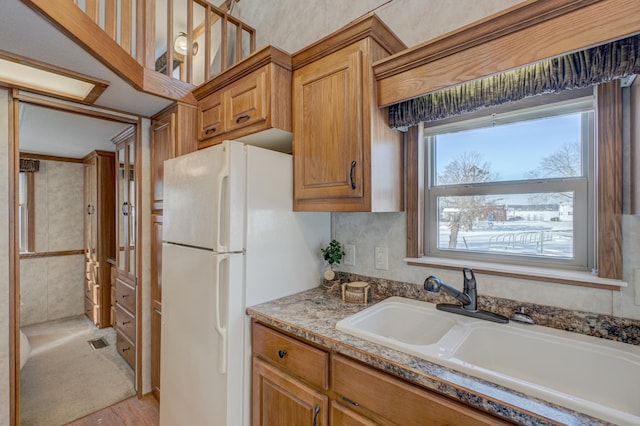 kitchen with white refrigerator and sink