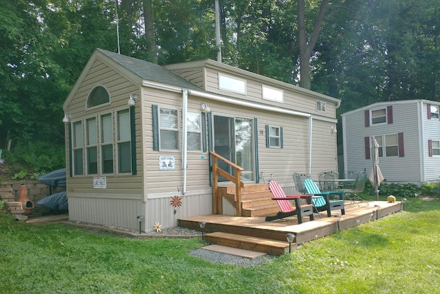 rear view of property with a yard